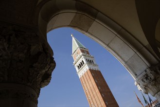 ITALY, Veneto, Venice, The Campanile in Piazza San Marco seen through an arch below the Doges