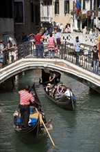 ITALY, Veneto, Venice, Gondolas with tourists passing along the Rio del Palazzo canal with its many