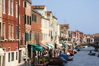 ITALY, Veneto, Venice, Tourists walking along the Fondamenta dei Vetrai with boats moored on the