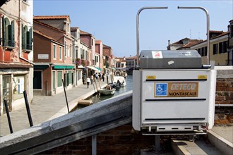ITALY, Veneto, Venice, A mechanically operated wheelchair ramp on a bridge across the Rio dei