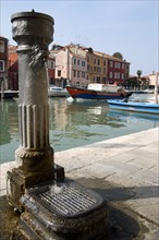 ITALY, Veneto, Venice, A free public drinking water fountain on the Canale di San Donato on the