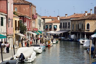 ITALY, Veneto, Venice, Tourists walking past shops along the Fondamenta dei Vetrai with boats