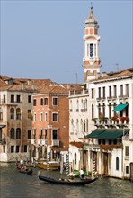 ITALY, Veneto, Venice, Gondolas with sightseeing tourists on the Grand Canal with the bell tower of