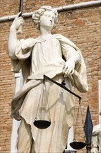 ITALY, Veneto, Venice, A female statue holding the scales of justice standing outside the entrance