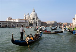 ITALY, Veneto, Venice, Gondolas with sightseeing tourists on the Grand Canal in front of the