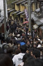 JAPAN, Honshu, Kyoto, Crowded lane in Sannen-zaka - wooden houses shops teahouses and tourists