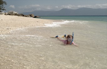 AUSTRALIA, Queensland, Fitzroy Island, Child Snorkelling on Nudie beach