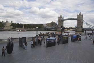 ENGLAND, London, The Queens walk open air exhibition outside the GLA city hall with Tower Bridge