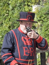 ENGLAND, London, Tower of London guard speaking on walkie talkie. Yeoman Warder Beefeater