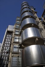 ENGLAND, London, Lloyds of London building polished metal exterior with elevators on the outside.