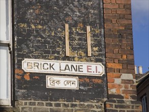 ENGLAND, London, "Whitechapel, Brick Lane bi-lingual street sign in English and Arabic. East End"
