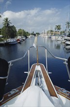 USA, Florida, Fort Lauderdale, View of Canal from boats bow with yachts moored outside waterfront