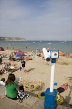 ENGLAND, Dorset, Swanage Bay, View over busy sandy beach with sunbathers on the sand towards the