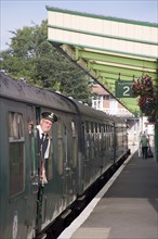 ENGLAND, Dorset, Swanage, Steam Railway Station. View along platform with train departing from