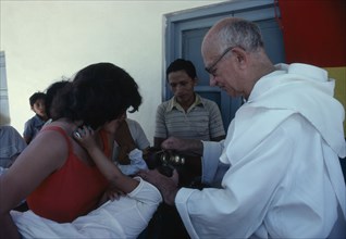 RELIGION, Baptism, Christening, "Priest pouring holy water over infants head, La Forestal, Bolivia