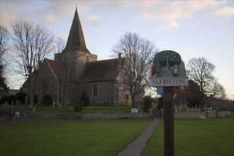 ENGLAND, East Sussex, Alfriston, St Andrew’s church in a warm evening light.