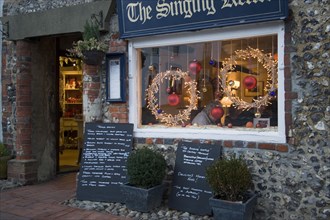 ENGLAND, East Sussex, Alfriston, Cafe with window decorated for Christmas.