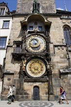 CZECH REPUBLIC, Bohemia, Prague, Old Town. People walking past the Astronomical clock on the tower