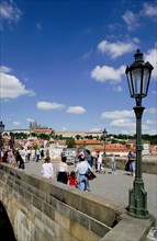 CZECH REPUBLIC, Bohemia, Prague, Tourists on the Charles Bridge across the Vltava River with Prague
