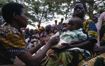 UGANDA, Medical, Health worker giving nutritional advice to mothers with vulnerable babies during