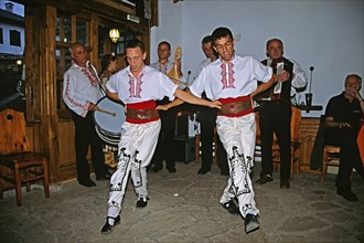 BULGARIA, Arbanassi, Male dancers in national costume dancing.