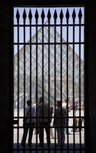 FRANCE, Ile de France, Paris, Tourists outside the pyramid entrance to the Musee du Louvre