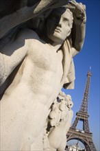 FRANCE, Ile de France, Paris, Stone sculptures in the Jardin du Trocadero with the Eiffel Tower