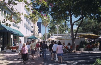 USA, Florida, Miami, South Beach. Lincoln Avenue. People walking under trees on pedestrian
