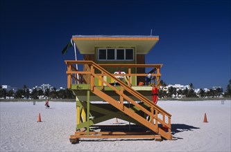USA, Florida, Miami, South Beach. Ocean Drive. Orange and Green Lifeguard station on sandy beach