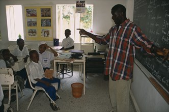 NIGERIA, Kano, Teacher and pupils in classroom of private school.