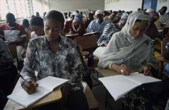 NIGERIA, Kano, Students writing at desks in law school.