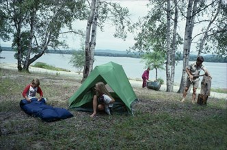 CANADA, North, Camping, "Canadian family on outback holiday setting up camp beside lake.  Children