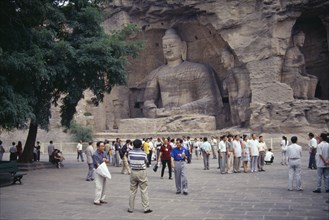CHINA, Shanxi, Datong, Yungang Caves.  Chinese visitors at ancient Buddhist site with rock carvings