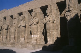 EGYPT, Nile Valley, Karnak, Temple of Amun. Osiride Pillars. Statues with crossed arms bearing the