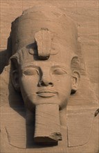 EGYPT, Nile Valley, Abu Simbel, Ramses II colossal enthroned statue. Detail of head