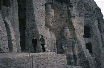 CHINA, Shanxi, Datong, Yungang Caves.  Chinese visitors at ancient Buddhist site with carvings