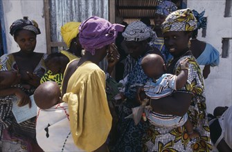 GAMBIA, Medical, Women and children queuing outside rural clinic.