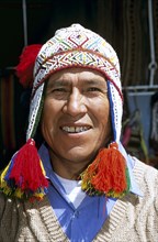 PERU, Cusco, "Peruvian man wearing colourful traditional hat with tassels, in Mercado del