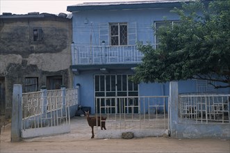 NIGERIA, Kano, "Typical house with blue painted exterior, white metal balcony and courtyard with