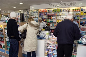 ENGLAND, East Sussex, Shoreham by sea, Interior of high street dispensing chemist  with customers