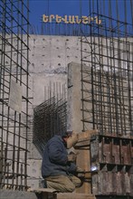 ARMENIA, Yerevan, Welder working on building of new cathedral to mark 1700 years of state