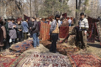 ARMENIA, Yerevan, Carpet sellers and customers at Vernisarge weekend market.