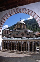 BULGARIA, Rila, "Nativity Church from balcony through arch, Rila Monastery."