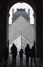 FRANCE, Ile de France, Paris, Tourist family passing through the Richelieu wing of the Louvre