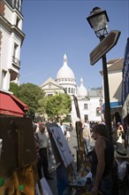 FRANCE, Ile de France, Paris, Montmartre Tourists walking past artists painting in Place du Tertre
