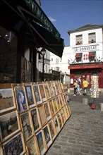 FRANCE, Ile de France, Paris, Montmartre Tourists walking past a shop selling prints of