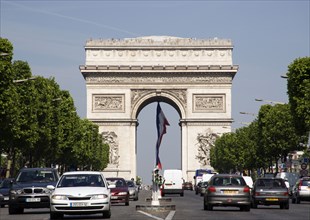 FRANCE, Ile de France, Paris, Traffic in the Champs Elysees leading to the Arc de Triomphe in Place