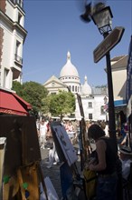 FRANCE, Ile de France, Paris, Montmartre Tourists walking past artists painting in Place du Tertre
