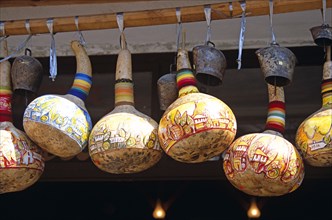 BULGARIA, Melnik., Colourful gourds and cattle bells hanging outside shop.