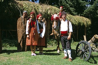 BULGARIA, Pirin Mountain, Chalin Valog, Girls dressed in Bulgarian national costume and men dressed